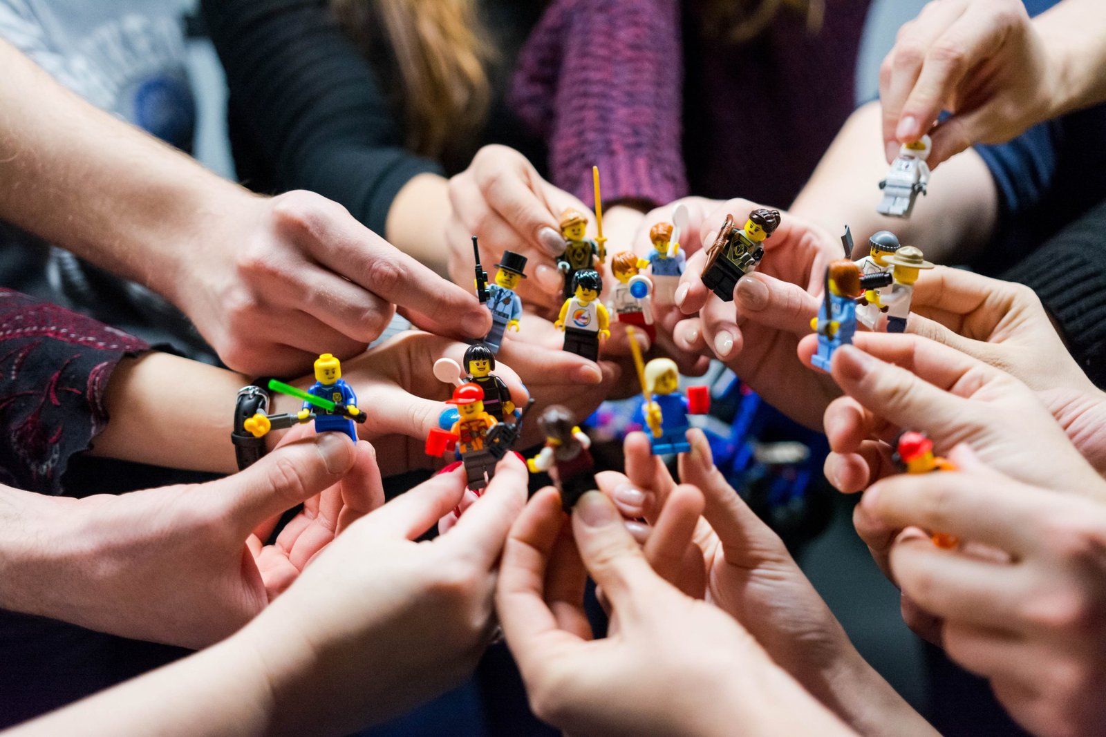 work colleagues holding legos for a team building excercise